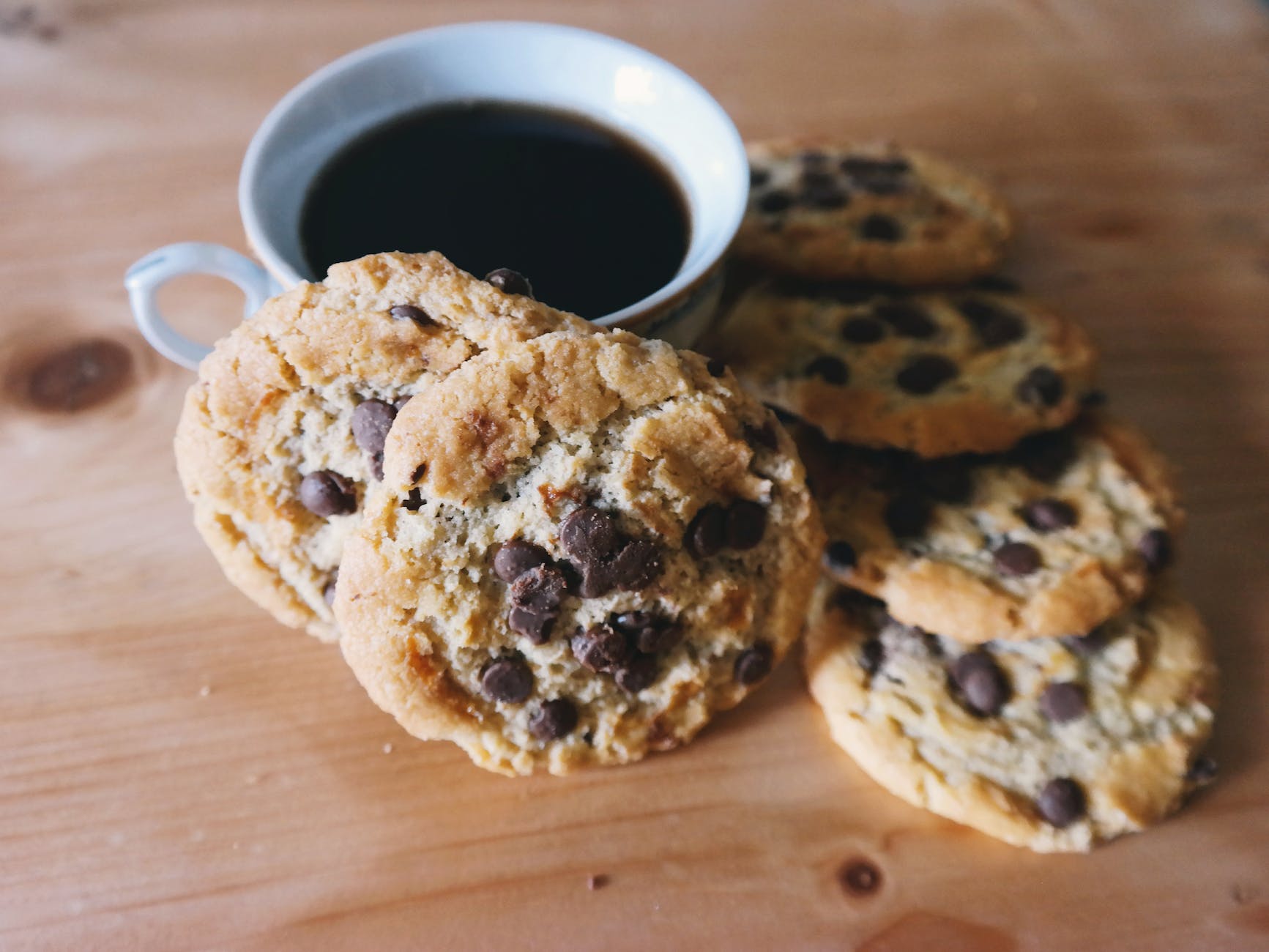 cup of coffee and cookies on table